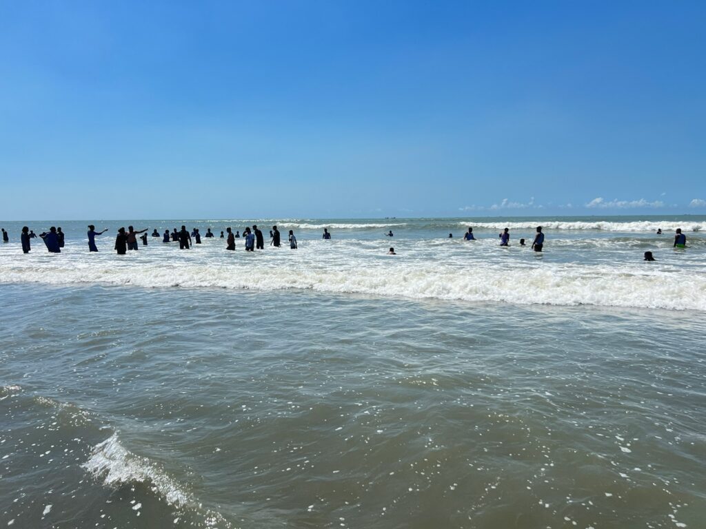 A group of people standing in the ocean