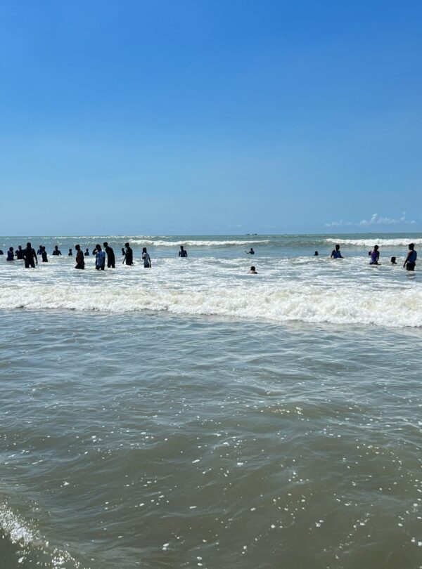 A group of people standing in the ocean