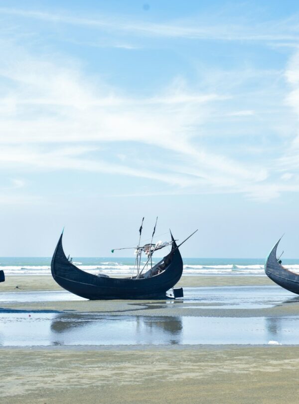 blue and white boat on sea under blue sky during daytime