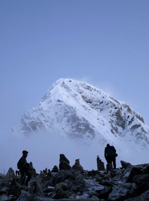 mountaineers near snow-covered mountain
