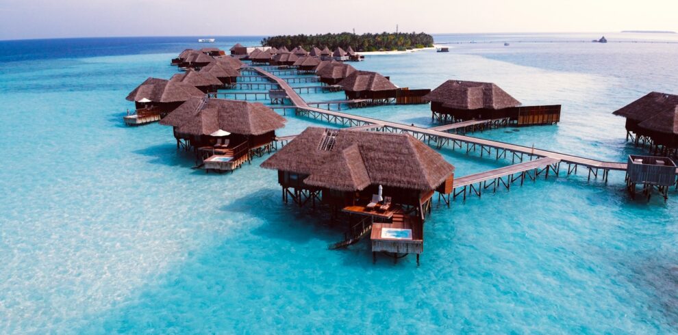 brown wooden cottage on blue body of water during daytime