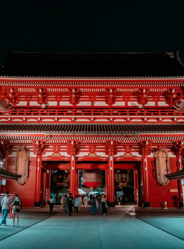 a red asian building with a black roof
